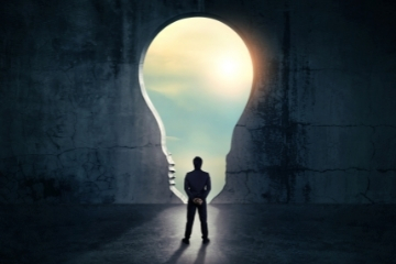 Person standing in front of a keyhole shaped light